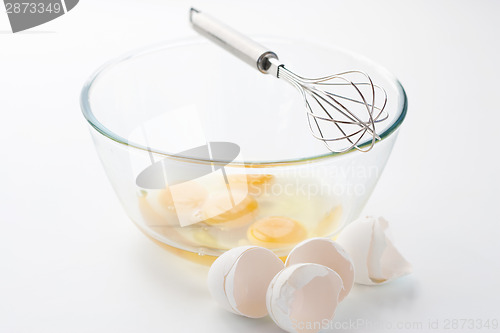 Image of Whisk with eggs in a bowl