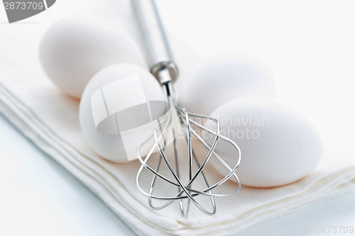 Image of Whisk and fresh eggs