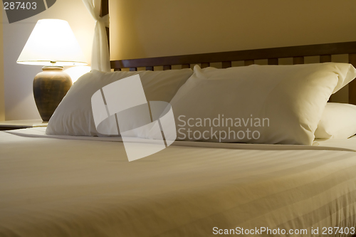 Image of King sized bed in a hotel suite room

