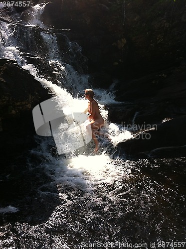 Image of woman in waterfall