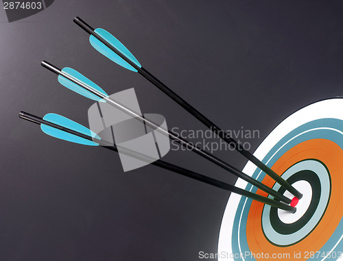 Image of Three Blue Black Archery Arrows Hit Round Target Bullseye Center
