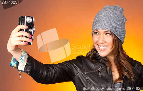 Image of Hip Woman Snaps a Self Portrait with Vintage Camera