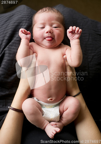 Image of Newborn Infant Baby Girl in Mothers Caring Arms Wearing Diaper