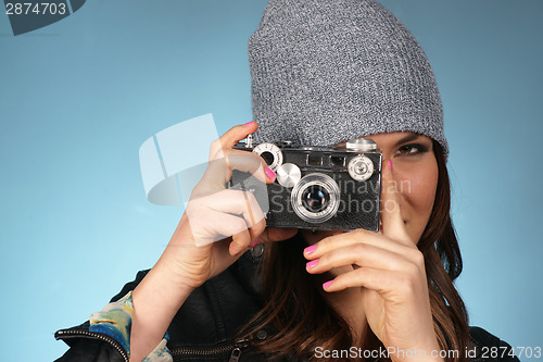 Image of Hip Woman Snaps a Picture of Viewer with Vintage Camera