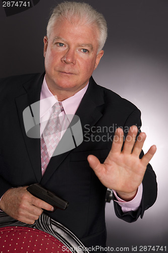 Image of Business Man Defends Himself Holding Small Semi Sutomatic Handgu