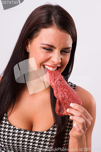 Image of Beautiful Brunette Woman Bites Raw Red Steak Meat Eater