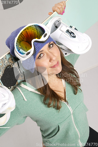 Image of Snowboard and Fun Loving Female in Teal