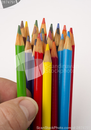 Image of Fingers Touch a Green Color Pencil from A Group