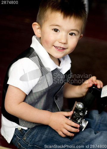 Image of Happy Young Boy in Vest Plays Around With Vintage Camera