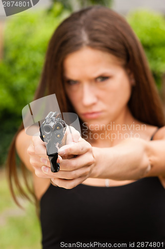 Image of Angry Beautiful Brunette Woman Points Loaded Handgun Self Defens