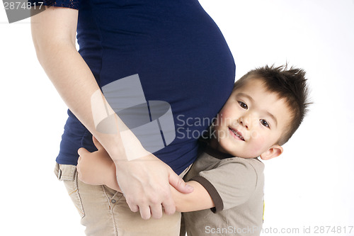 Image of Firstborn Child Boy Hugs Mothers Pregant Belly Ready for Sister