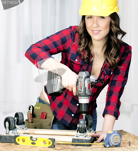 Image of Woman Works on a Bench Repairing A Dolly