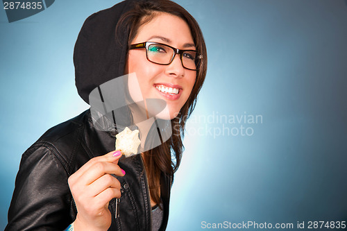Image of Young Woman Smiles While Chewing a Bite of Chips