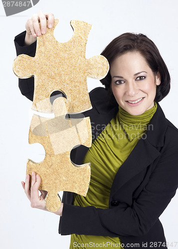 Image of Woman Working With Two Large Jigsaw Puzzle Pieces