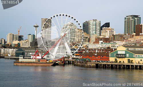 Image of Waterfront Piers Dock Buildings Needle Ferris Wheel Seattle Elli