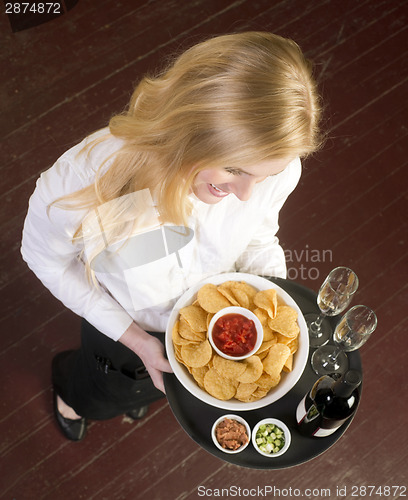 Image of Young Attractive Female Server Brings Wine and Appetizer Food Tr