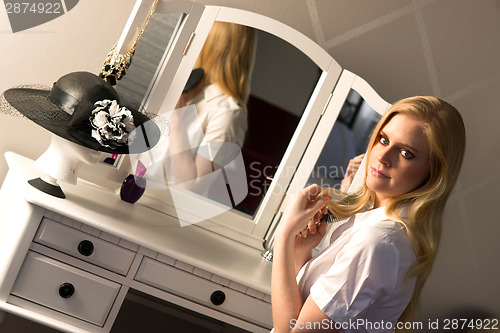 Image of Beautiful Blonde Woman Brushing Hair Bedroom Vanity Natural Beau