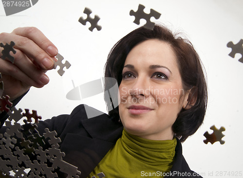 Image of Business Woman Working a Jigsaw Puzzle