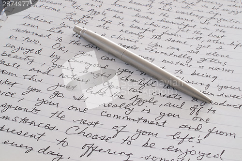 Image of Stainless Steel Pen Laying on Written Page