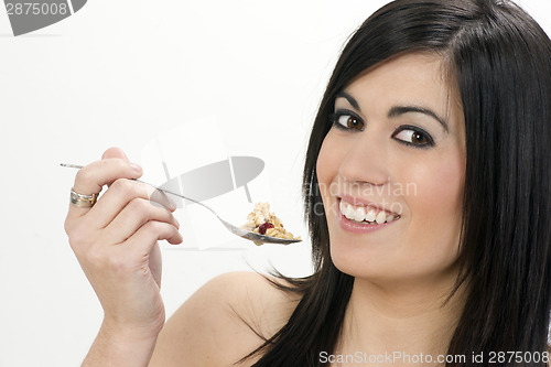 Image of Smiling Young Adult Woman Eats Cereal With Fruit