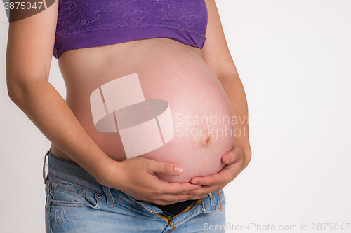 Image of Pregnant Woman Expecting Baby Torso Standing Hands on Belly