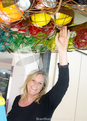 Image of Attractive Female Glassblower Artist Adjusts Art Installation Sm