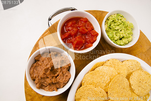 Image of Chips Salsa Refried Beans Guacamole Nachos Food Fresh Appetizer