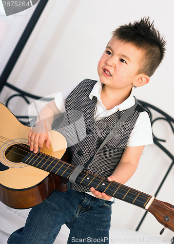 Image of Young Boy Jamming Full Size Guitar Gritting Teeth Playing Musici