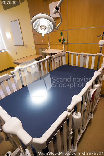 Image of Medical Inspection Light Shines Down Bed Childrens Hospital Room
