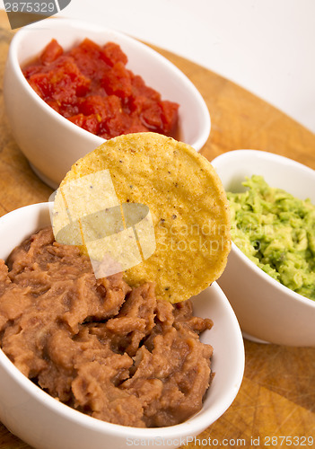 Image of Chips Salsa Refried Beans Guacamole Nachos Food Fresh Appetizer