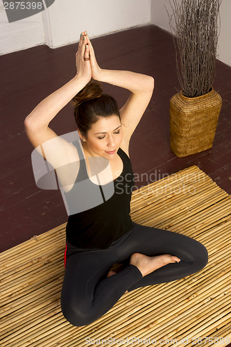 Image of Woman Stretched Upward From Seated Yoga Practice Meditation Posi