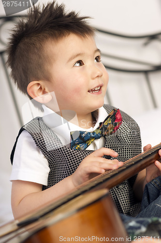 Image of Happy Two Year Old Boy Interested in Arts and Music