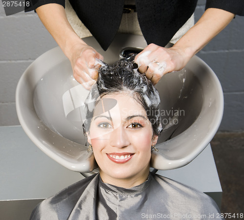 Image of Attractive Woman Gets Spa Salon Shampoo and Conditioning