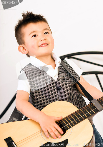 Image of Young Boy Jamming Full Size Guitar Gritting Teeth Playing Musici