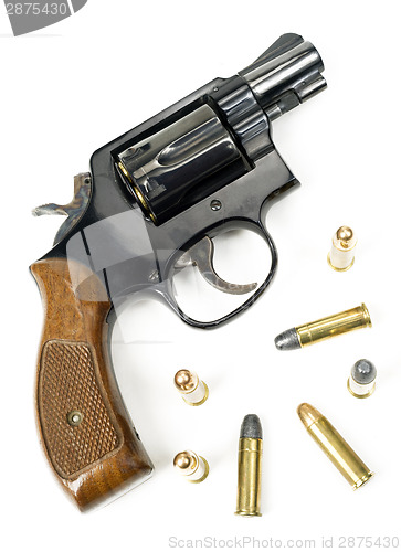 Image of Wood Handled Revolver 38 Caliber Pistol Loaded Laying With Bulli