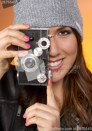 Image of Woman Looks Right at the Camera taking a picture too