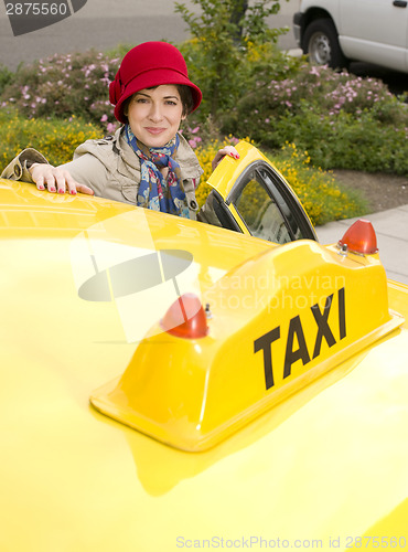 Image of Woman enters a Taxi