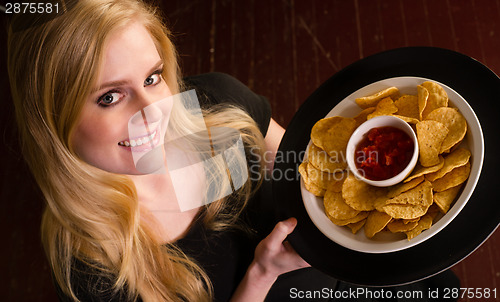 Image of Young Attractive Female Server Brings Appetizer Chips Salsa Food