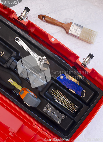 Image of Orange Tool Box with Crescent Tape and Brush