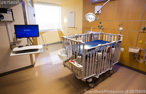 Image of Medical Inspection Light Shines Down Bed Childrens Hospital Room