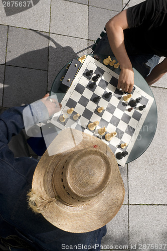 Image of Man Moves Piece People Playing Chess Game Sidewalk Park Downtown