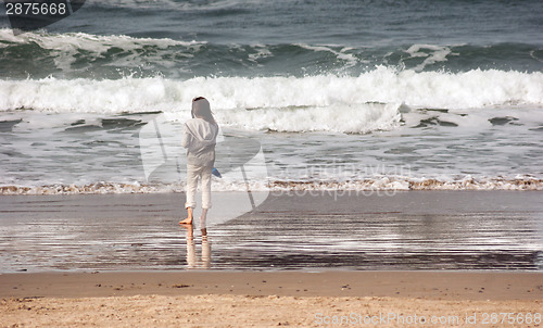 Image of Young Girl Looks Out Ocean Surf Sand Shovel West Coast