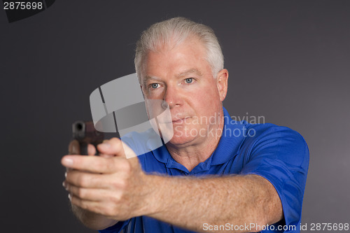 Image of Man Defends Himself Holding Pointing Small Semi Sutomatic Handgu