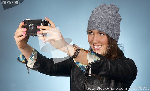 Image of Hip Woman Snaps a Picture of Herself with Vintage Camera