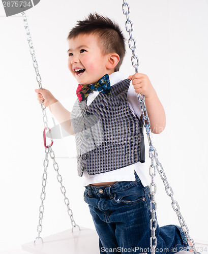 Image of Happy Young Boy Plays Swing Suspended Moving Laughing Child Play