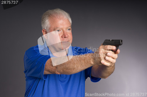 Image of Man Defends Himself Holding Pointing Small Semi Sutomatic Handgu