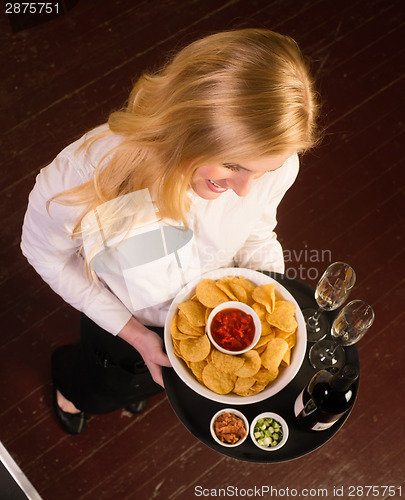 Image of Young Attractive Female Server Brings Tray Chips Salsa Bean Appe