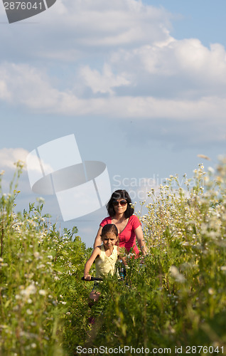 Image of Mother and daughter cycling