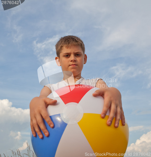 Image of Young boy with beach ball