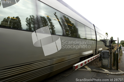 Image of French train passing through unmanned level crossing, chenonceau, loire valley, france